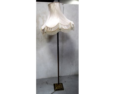 A gilt metal standard lamp in the form of a Corinthian column on a stepped square base, height 129cm. CONDITION REPORT Please