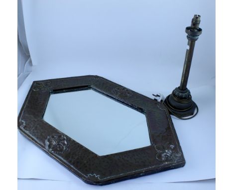 An Arts &amp; Crafts beaten copper wall mirror of lozenge shape with fleur-de-lys to the top and bottom and open rose either 