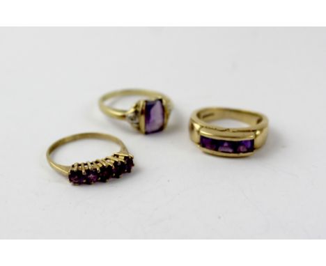 A 9ct gold dress ring set with five purple stones, size I, a 9ct gold ring set with three purple stones, size G, and a 9ct go