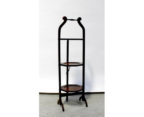 An early 20th century mahogany three-tier folding cake stand on outswept feet, height approx 90cm, and a vintage metal travel