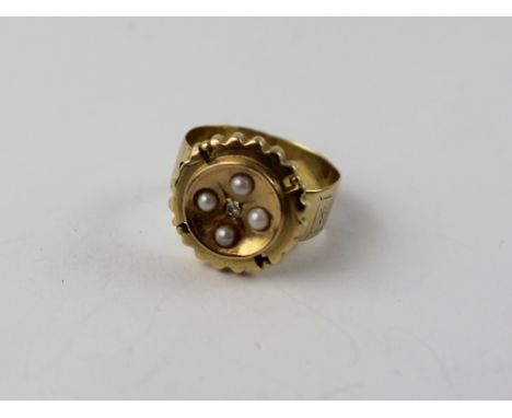 An Edwardian 9ct gold dress ring set with four seed pearls and diamond chip, Size K, approx 3g.