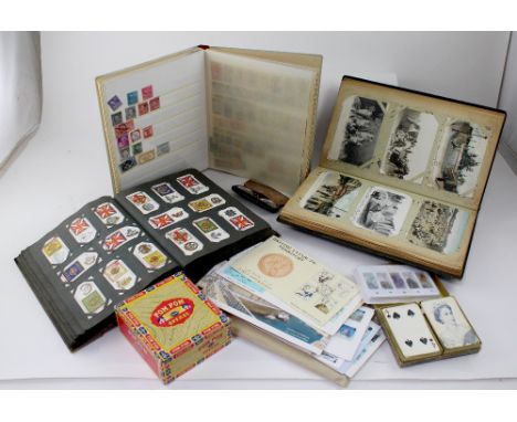 A collectors' lot to include postcard albums, a cigarette card album, a stamp album, silks and playing cards etc.