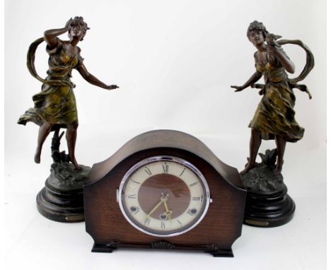 After Moreau (French); a pair of bronzed spelter figures 'L'Hesitation' and 'Le Charme' and an oak-cased mantel clock (3).