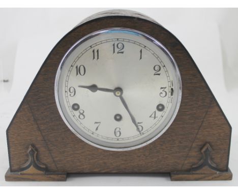 An early 20th century oak-cased mantel clock with silvered dial, height 22cm and a modern brass-cased quartz mantel clock (2)