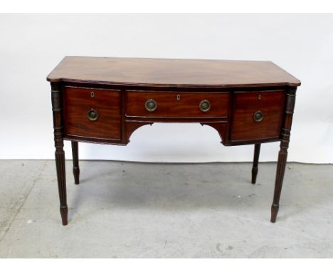 A 19th century mahogany bow-front sideboard, the top shaped with corner lugs and fitted glass top, central drawer flanked by 