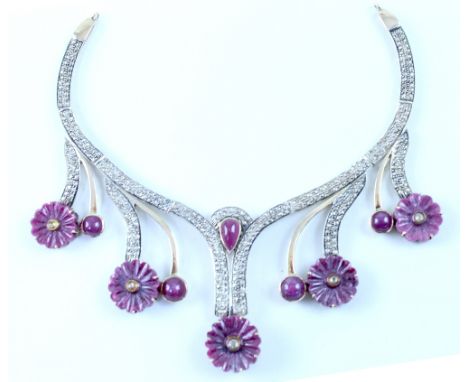 An Art Deco style diamond and ruby necklace, small diamonds in gold mounts to flower heads with cabochon set drops, together 