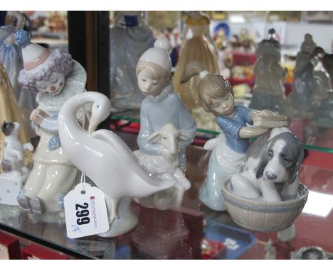 Lladro Pierrot, 'A-2S', Kneeling Boy with Lamp, Girl Washing Dog and Swan, 10.5cm high. (4)