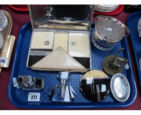 An Art Deco Ladies Combination Compact, rectangular, in cream enamel, with carry handle; a black and cream circular powder co