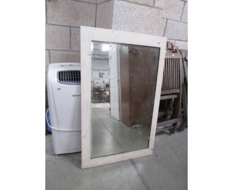 A white framed bevel edged mirror