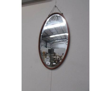 An oval bevel edged mirror