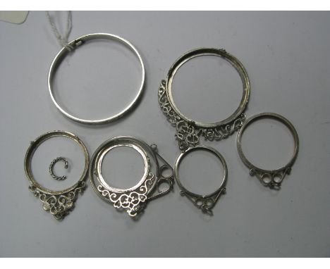 A Hallmarked Silver Child's Bangle, together with six assorted coin pendant mounts, one "1952 EIIR 1977" commemorative etc. (