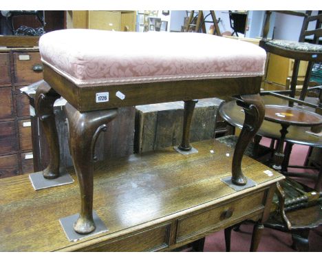 A Walnut Stool, with an upholstered top on cabriole legs, with C scroll decoration on pad feet (converted from a commode)