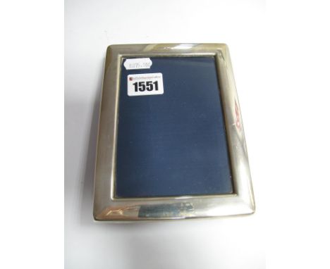 A Modern Hallmarked Silver Mounted Rectangular Photograph Frame, of plain design, on velvet easel back, overall height 16cm.