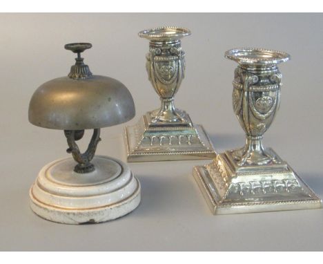 White metal reception bell on ceramic base, together with a pair of silver plated repousse decorated Adam style, vase-shaped 