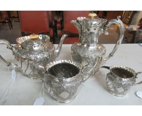 Ornately decorated white metal Continental tea and coffee set comprising: coffee pot with a bone finial, matching teapot, suc