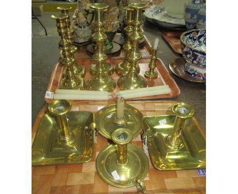 Two trays of brass candlesticks to include: three pairs of candlesticks and four bedside candle holders, as well as one small