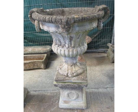 Modern composition urn-shaped fluted classical design planter with loop handles, standing on a rectangular square stepped pli