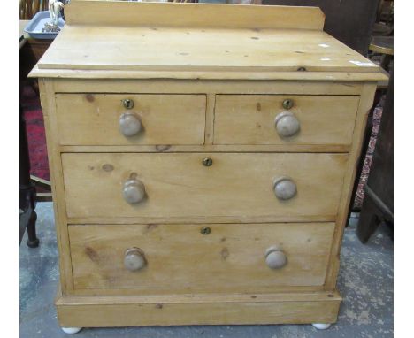 Victorian pine straight front chest with two short and two long drawers, on projecting base and standing on ceramic pad feet.