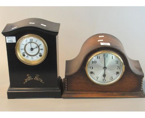 Early 20th century oak hat-shaped three train mantel clock with silvered face, together with a ebonised two-train mantel cloc