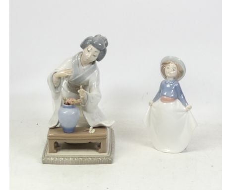 Lladro, Geisha with flower arrangement a/f flowers, together with small Nao girl in summer dress. (2)