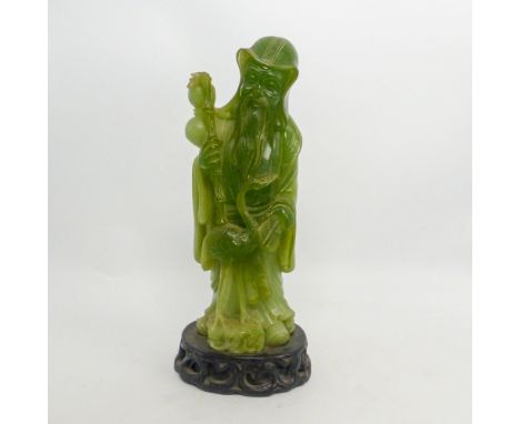 Chinese Resin Faux Jade hand carved figure with a bird, on a base that is marked. (H:24cm)