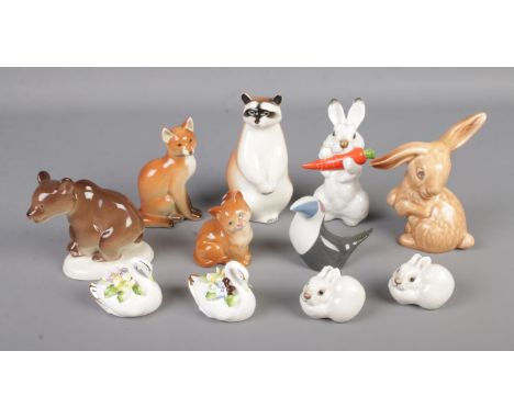 A collection of ceramic animal figures to include Royal Dux Toucan, Royal Doulton cat, assorted Lomonosov examples, etc.  