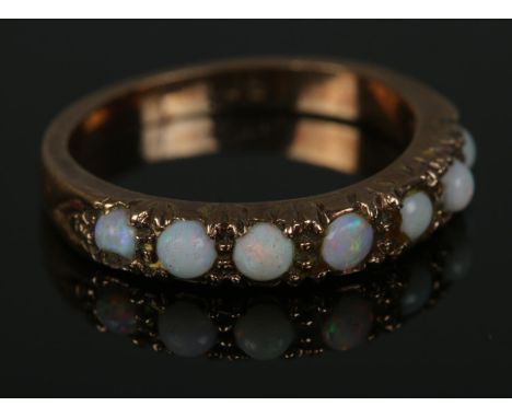 A 9ct gold seven stone opal ring.2.4gSize K  