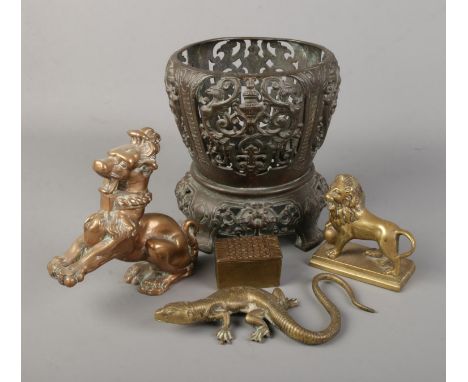 A collection of bronze and brass items. Includes oriental planter stand, box, lizard, lion and a temple lion.  