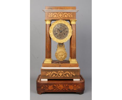 A 19th century French inlaid rosewood Portico clock. Height on stand 47.5cm.  Clock winds okay.