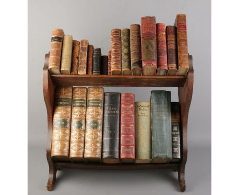 An oak two tier book trough with contents of antique books. Includes British Quadrupeds, Servants Magazine 1868, Poetry, Char