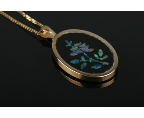 A gold mounted opal mosaic pendant formed as a flower, on 9ct Gold necklace chain. Total weight: 2.1g.  