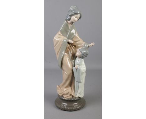 A Nao figure group of a Geisha mother and child. Height 37cm.  