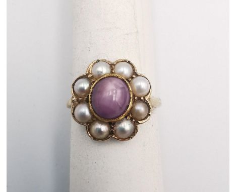 A Victorian Star ruby and cultured pearl and yellow metal (tests higher than 9ct) cluster ring. Set to the centre with a cabo