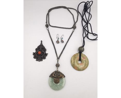 A collection of Chinese jewellery, including a jade Bi disc pendant, a silver and coral fish pendant and a pair of coral and 