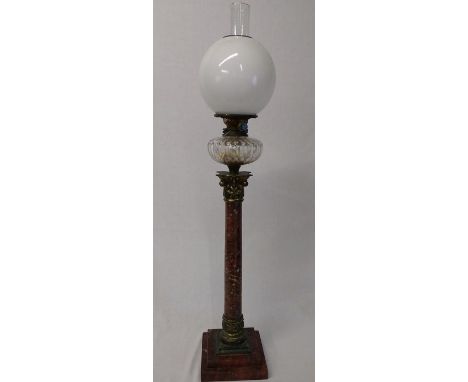 Large Victorian paraffin lamp on marble column with opaque shade, clear cut glass reservoir above a Corinthian column on a st