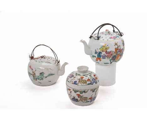 TWO FAMILLE ROSE PORCELAIN TEAPOTS
Both of spherical form, one example decorated with figures riding a qilin, the other examp