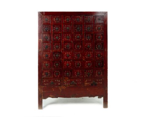 A CHINESE RED LACQUERED MEDICINE CABINET
With multiple square fitted drawers, carved front and calligraphic decoration
159cm 