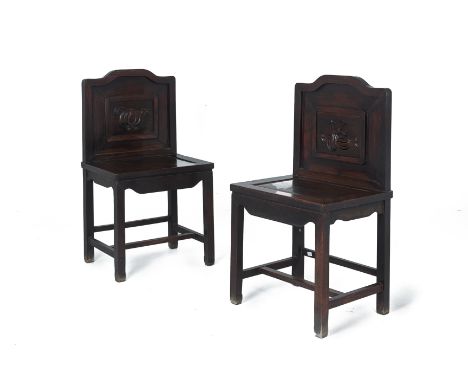 A PAIR OF CHINESE HARDWOOD SIDE CHAIRS The arched back rest with inset carved wood panel of melons, rectangular solid seat on