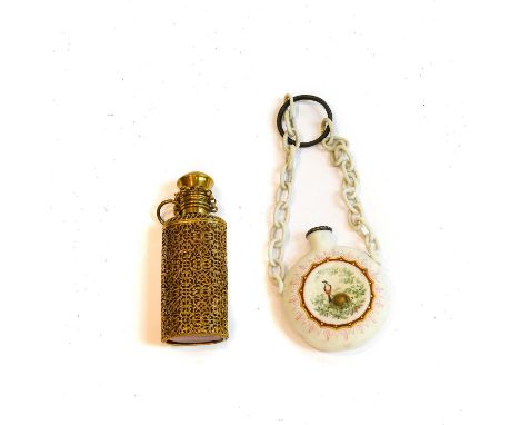 Two scent-bottles, one of light red glass with overall openwork brass mounts, 7.8cm high, the other of unglazed ceramic and w