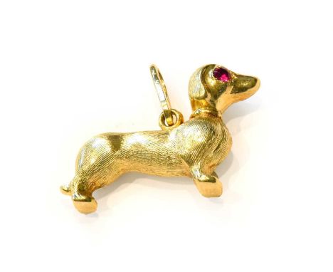 A dachshund pendant/charm, with synthetic ruby eyes, bale stamped '585', length 2.7cmCondition report: Gross weight 2.3 grams