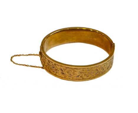 A 9 carat gold hinged bangle, inner measurements 6.0cm by 5.1cmCondition report: Gross weight 22.0 grams.