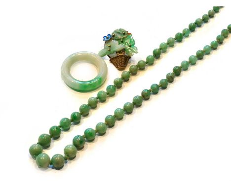 A jade bead necklace, length 46cm; a jade ring, finger size U; and a jade and enamel brooch/pendant, length 3.6cmCondition re