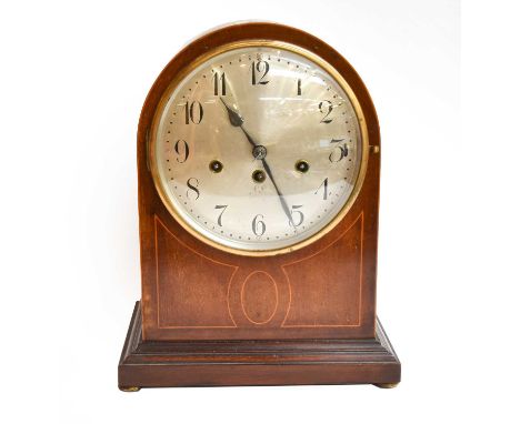 A German mahogany cased eight day striking mantle clock with silvered dial, housing a Junghaans movement striking on gong rod