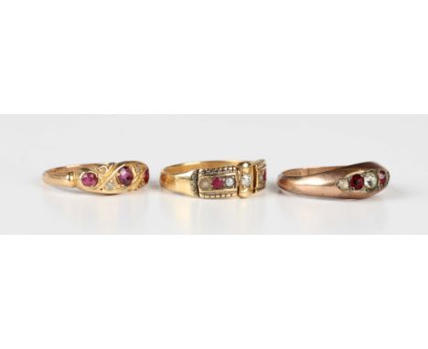 An Edwardian 18ct gold, ruby and diamond ring, mounted with three cushion cut rubies between two rose cut diamonds in a twist