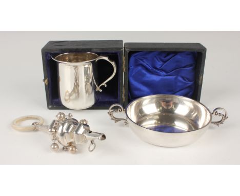 A late 19th/early 20th century silver hexagonal shaped child's rattle with whistle terminal, hung with six bells, fitted with