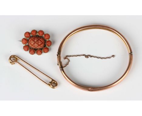 A late Victorian 9ct gold oval hinged bangle, inside width 5.3cm, a gold safety pin brooch, detailed '9ct', total weight 9.6g
