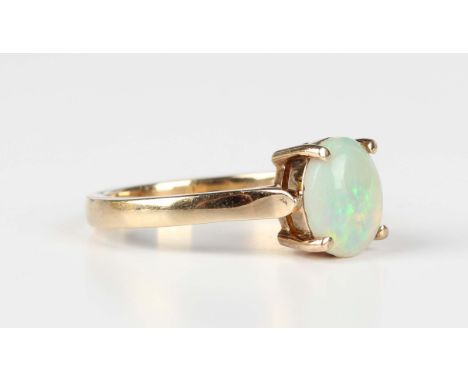 A gold ring, claw set with an oval opal, detailed '9ct', weight 4.4g, ring size approx S.Buyer’s Premium 29.4% (including VAT