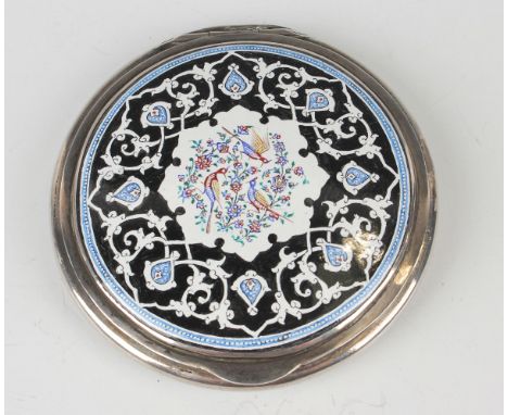 A 20th century Persian silver and enamel circular compact, the hinge lid painted with birds amidst flowers within a strapwork