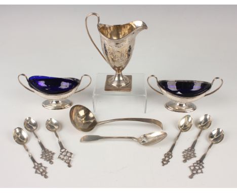 A George III silver cream jug of ovoid form with loop handle, engraved with foliate garlands, on a circular foot and square b