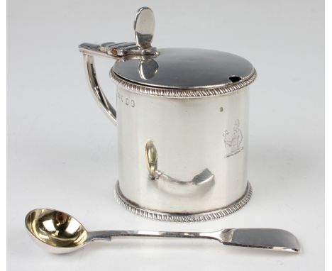 A George III silver cylindrical mustard with hinge lid and gadrooned borders, fitted with a blue glass liner, London 1804 by 
